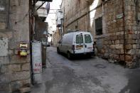 A street corner in Jerusalem's Mea Shearim neighbourhood where Ultra-Orthodox Jewish men sort their cooking utensils at they dip them in boiling water to remove remains of leaven in preparation for the Jewish holiday of Passover, seen deserted amid the cor