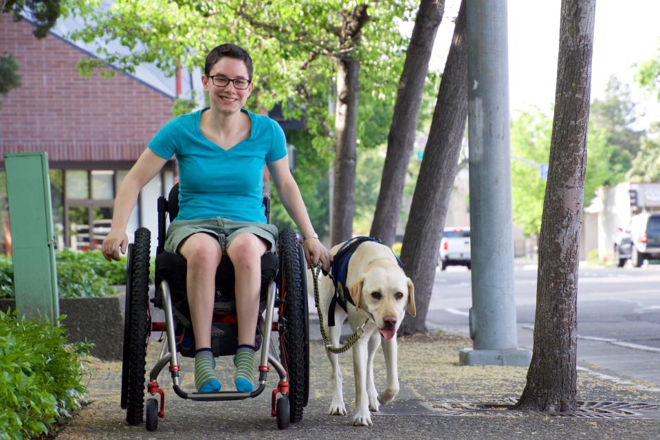 Wallis Brozman is photographed in 2018 with her former service dog Mork. However, Mork had to be taken out of service after being attacked by other dogs several times in public places where pets were not permitted.