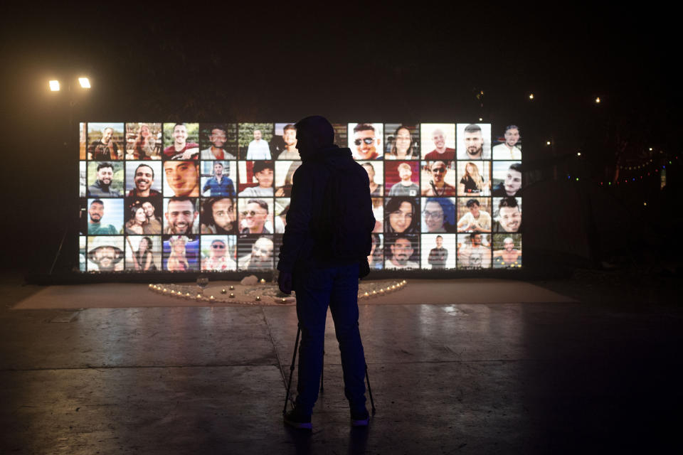 A journalist films a display of people who were killed at the Nova music festival in an Oct. 7 cross-border attack by Hamas, during a press tour of the 06:29 memorial recreating the festival grounds on the day of the massacre, in Tel Aviv, Israel, Wednesday, Dec. 6, 2023. (AP Photo/Maya Alleruzzo)