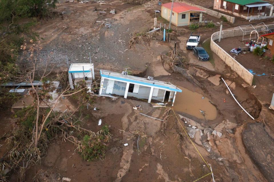 A house lays in the mud after it was washed away by Hurricane Fiona at Villa Esperanza in Salinas, Puerto Rico, Wednesday, Sept. 21, 2022. Fiona left hundreds of people stranded across the island after smashing roads and bridges, with authorities still struggling to reach them four days after the storm smacked the U.S. territory, causing historic flooding. (AP Photo/Alejandro Granadillo)