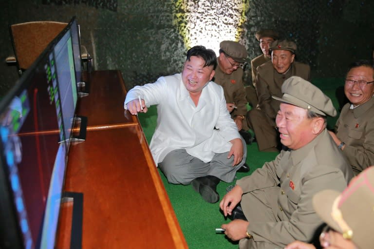 North Korean leader Kim Jong-Un (C) inspects a test-fire of strategic submarine-launched ballistic missile, at an undisclosed location on August 24, 2016