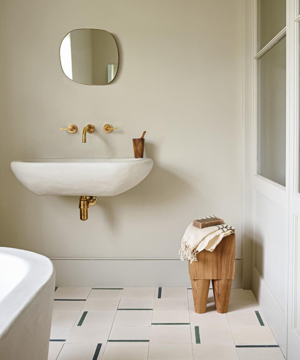 <p> One way to ensure your sustainable bathroom are achievable and beautiful is to look to reclaimed materials. Here, reclaimed cement tiles (Duo green stripe tiles, Otto Tiles &amp; Design) create an irregular patchwork underfoot &#x2013; an interesting backdrop for handcrafted furniture made from sustainably sourced wood by a British furniture maker. The walls are in Retreat limewash paint from the Visual Silence collection by House of Grey x Bauwerk, Bauwerk. </p>