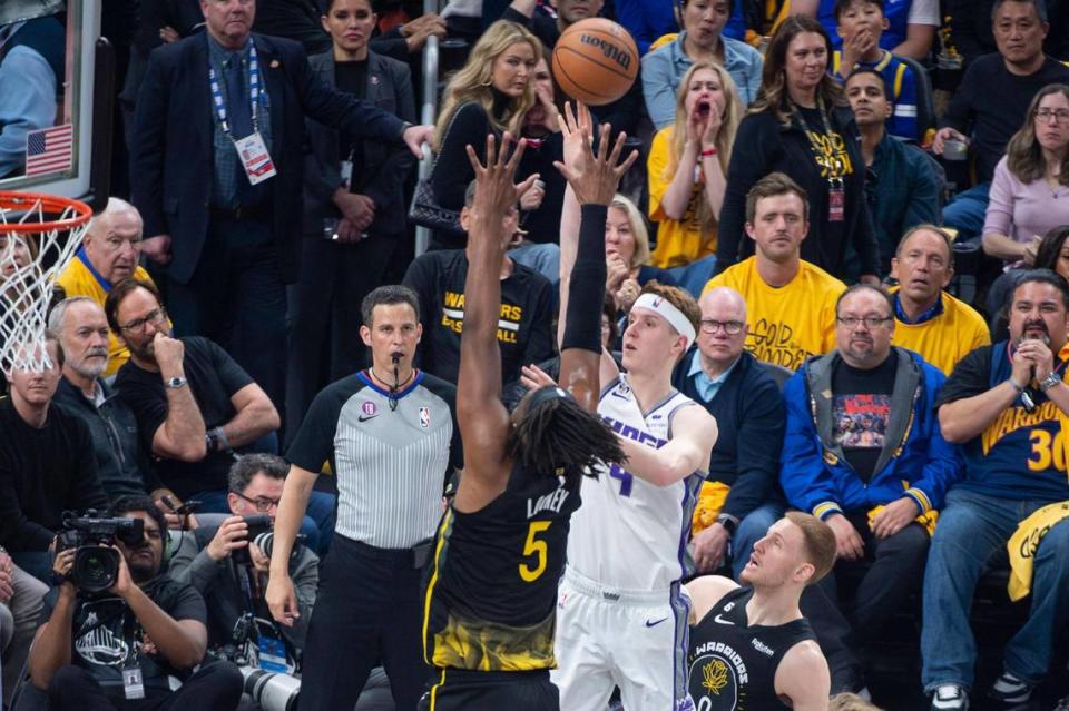 Sacramento Kings guard Kevin Huerter (9) shoots over Golden State Warriors forward Kevon Looney (5) in the first half during Game 3 of the first-round NBA playoff series at Chase Center in San Francisco on Thursday, April 20, 2023.