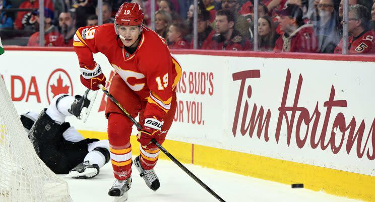 Calgary Flames left wing Matthew Tkachuk (19) chases after the puck after a collision with Los Angeles Kings defenseman Drew Doughty (8). (Candice Ward-USA TODAY Sports)