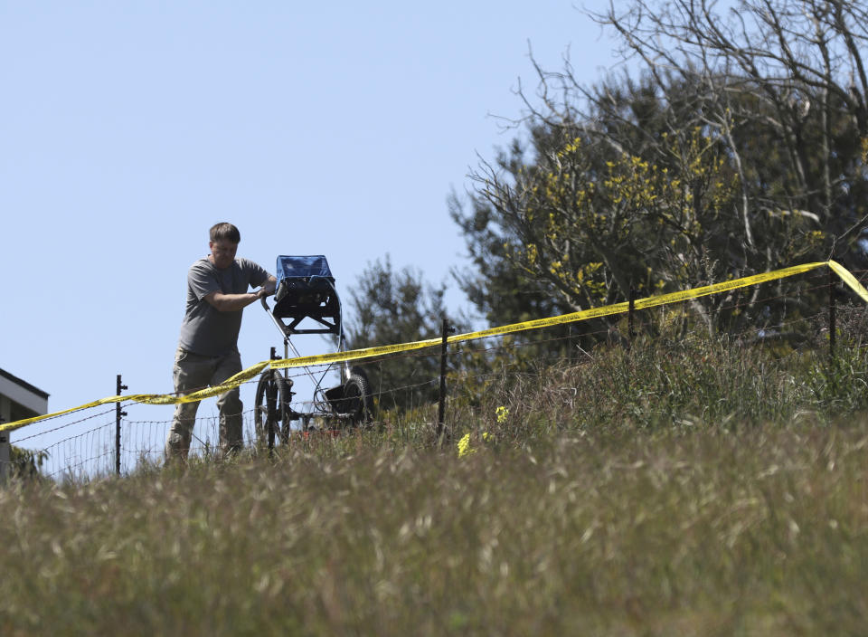 FILE - In this March 16, 2021, file photo, an investigator uses ground penetrating radar to search the backyard of the home of Ruben Flores, in Arroyo Grande, Calif. Flores is the father of Paul Flores, who remains the prime suspect in the disappearance of Kristin Smart in 1996. The San Luis Obispo County sheriff plans a major announcement Tuesday, April 13, 2021, in the nearly 25-year mystery of the disappearance of Smart. (AP Photo/Daniel Dreifuss, File)