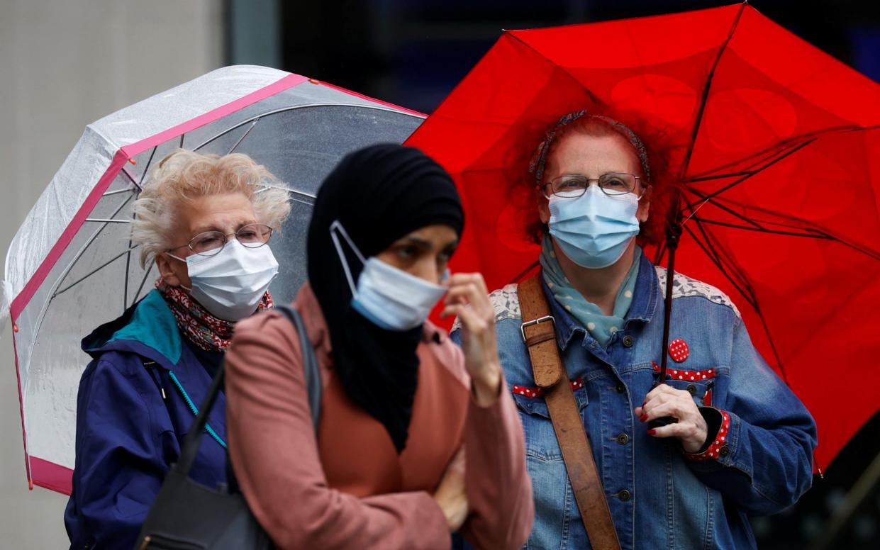 People wear protective masks as Blackburn with Darwen Council imposes local restrictions in an effort to avoid a local lockdown being forced upon the area, amid the coronavirus disease (COVID-19) outbreak, in Blackburn, - Phil Noble/REUTERS