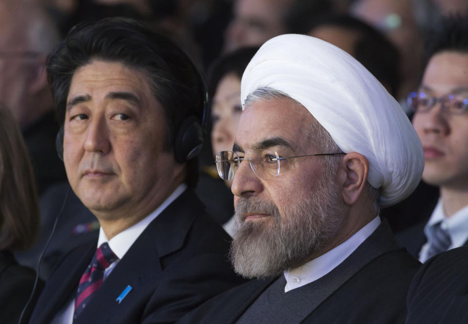 FILE - In this Jan. 22, 2014 file photo, Japanese Prime Minister Shinzo Abe, left, and Iranian President Hassan Rouhani, attend a session of the World Economic Forum in Davos, Switzerland. Abe's trip to Tehran on Wednesday, June 12, 2019, represents the highest-level effort yet to de-escalate tensions between the U.S. and Iran. The visit comes as Iran appears poised to break the 2015 nuclear deal it struck with world powers that America earlier abandoned. (AP Photo/Michel Euler, File)