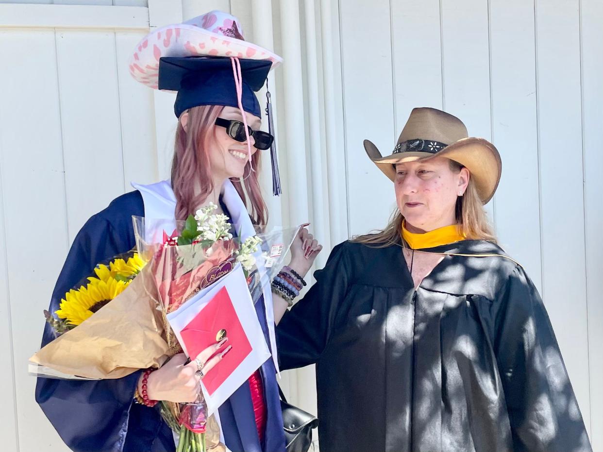 Luca Barrington-Lenders, left, poses with her graduation cowboy hat photo alongside advisor Eileen Belanger at Century Academy in Thousand Oaks on Tuesday, June 7, 2022.