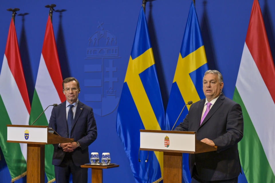 Sweden's Prime Minister Ulf Kristersson, left, listens his Hungarian counterpart Viktor Orban during a press conference at the Carmelite Monastery in Budapest, Hungary, Friday, Feb 23, 2024. Nearly two years after Sweden formally applied to join NATO, its membership now hinges on convincing one country - Viktor Orban's Hungary - to formally ratify its bid to join the military alliance. (AP Photo/Denes Erdos)