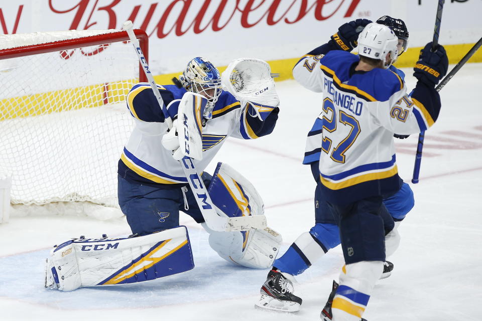 A Winnipeg Jets shot from the blue line zips past the head of St. Louis Blues goaltender Jordan Binnington and off the crossbar during the third period of an NHL hockey game Saturday, Feb. 1, 2020, in Winnipeg, Manitoba. (John Woods/The Canadian Press via AP)