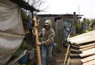 Business administrative student Andres Reyes Baltazar moves a wooden coat rack in the family’s furniture workshop, in the Purepecha Indigenous community of Comachuen, Michoacan state, Mexico, Wednesday, Jan. 19, 2022. Reyes' father has been going north to work since 2011 because, he says, in the furniture trade “sometimes there are customers, and sometimes there aren’t.” Asencion Reyes Julian spends much of the money he earns in New York to pay for his son’s education. (AP Photo/Fernando Llano)