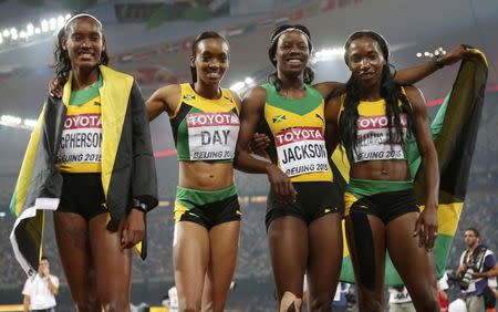 Stephenie Ann McPherson, Christine Day, Shericka Jackson and Novlene Williams-Mills of Jamaica react after winning the women's 4x400m event during the 15th IAAF World Championships at the National Stadium in Beijing, China August 30, 2015. REUTERS/Lucy Nicholson