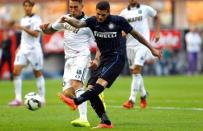 Inter Milan's Mauro Icardi (R) shoots to score against Sassuolo during their Serie A soccer match at San Siro stadium in Milan, September 14, 2014. REUTERS/Stefano Rellandini