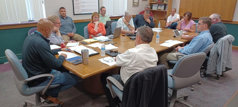 Sturgis City Commission and other city officials review information, as the commission considered applying for a state grant to help with parking lot improvements.