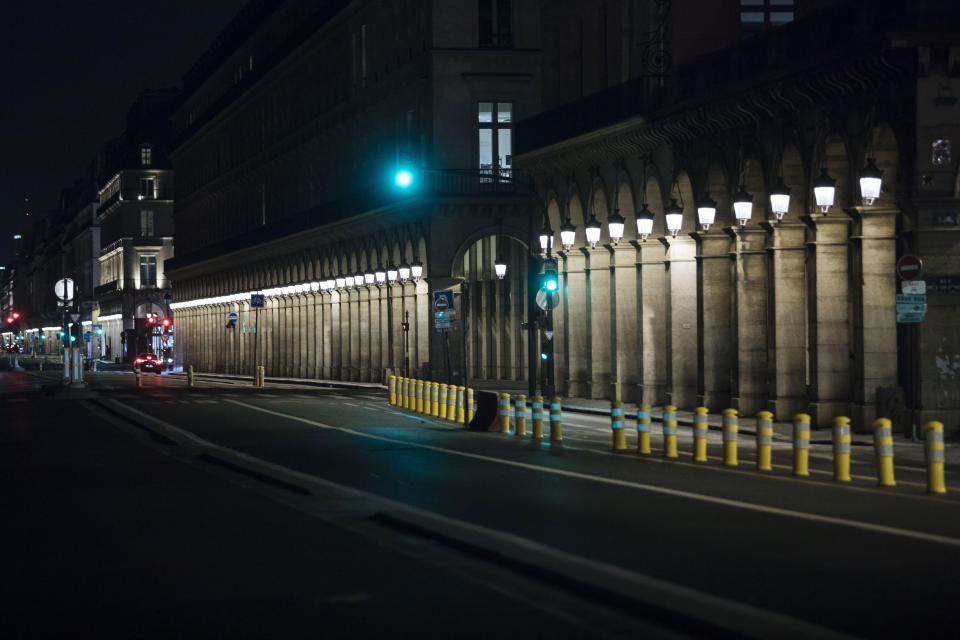 Rivoli street is empty during curfew in Paris, Saturday, Oct. 17, 2020. French restaurants, cinemas and theaters are trying to figure out how to survive a new curfew aimed at stemming the flow of record new coronavirus infections. The monthlong curfew came into effect Friday at midnight, and France is deploying 12,000 extra police to enforce it. (AP Photo/Lewis Joly)