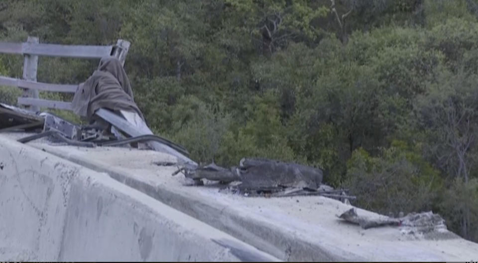 In this image taken from video provided by eNCA, a bus carrying worshippers headed to an Easter festival plunged off a bridge on a mountain pass and burst into flames in Limpopo, South Africa, on Thursday, March 28, 2024, killing multiple people, authorities said. (eNCA via AP)