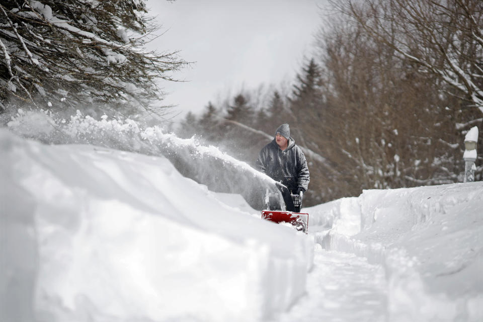 Gary Poulton uses a snowblower to slowly chip away at the massive amounts of snow covering a long driveway on Bates Rd. in Windsor, Mass., Wednesday, March 15, 2023, the day after a snow storm. (Stephanie Zollshan/The Berkshire Eagle via AP)