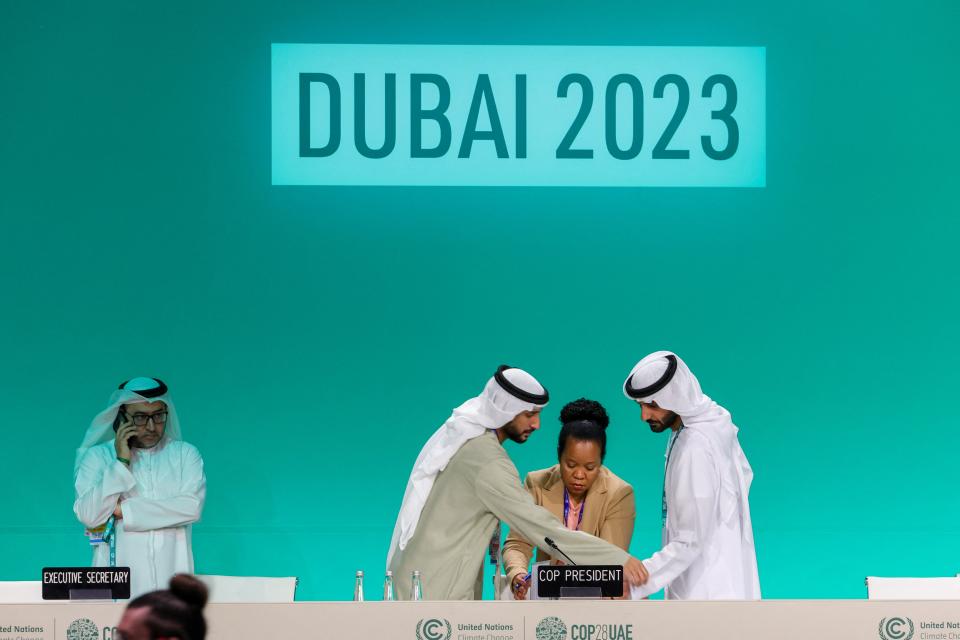 Officials prepare for a plenary session during the Cop28 United Nations climate summit in Dubai on 13 December 2023 (AFP via Getty Images)