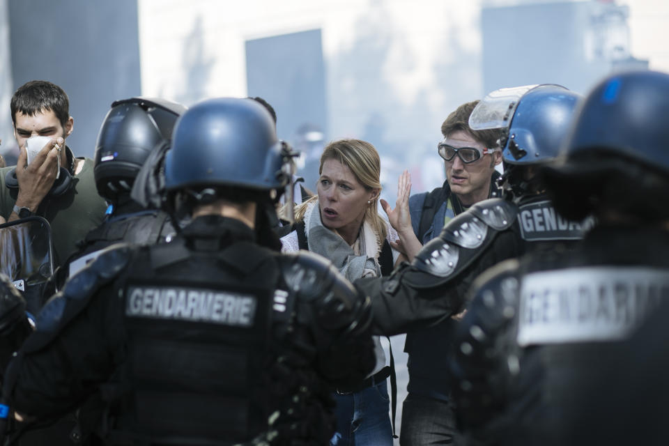 A woman gestures as she speaks with riot police officers during a yellow vests demonstration, in Paris, Saturday, Sept 21. 2019. Paris police have used tear gas to disperse anti-government demonstrators who try to revive the yellow vest movement in protest at perceived economic injustice and French President Emmanuel Macron's government. The French capital was placed under high security as few hundred anti-government protesters started marching in the Paris streets. (AP Photo/Kamil Zihnioglu)