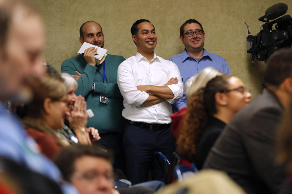 Former Housing and Urban Development Secretary and 2020 Democratic presidential hopeful Julian Castro, center, waits to speak at the Story County Democrats' annual soup supper fundraiser, Saturday, Feb. 23, 2019, in Ames, Iowa. (AP Photo/Charlie Neibergall)