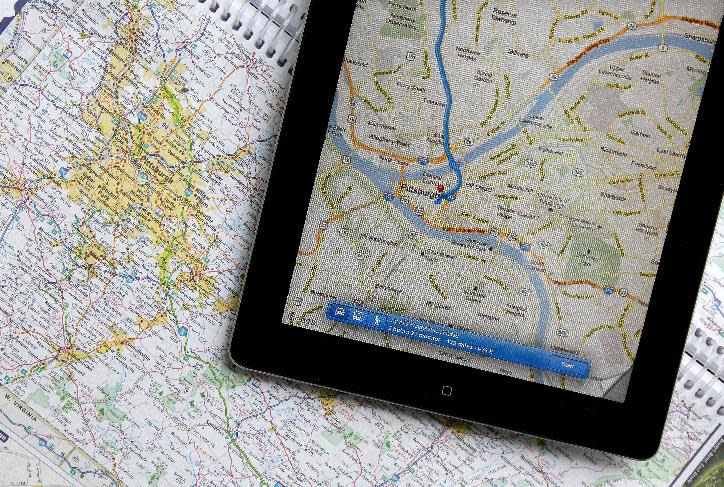 In this Tuesday, May 8, 2012 photo a traditional road map of the Pittsburgh area and one showing the same region on an iPad are seen placed together in Moreland Hills, Ohio. Transportation agencies around the country are printing fewer maps to cut costs or just to acknowledge that public demand is down. (AP Photo/Amy Sancetta)