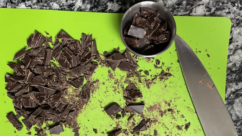 chopped chocolate with knife on cutting board