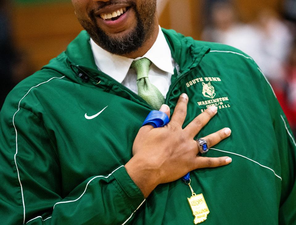 Washington head coach Steve Reynolds shows off his ring during the championship ring ceremony for the 2021-22 state championship team Tuesday, Nov. 15, 2022 at Washington High School.