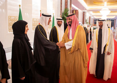 Saudi Arabia's Crown Prince Mohammed bin Salman Al Saud shakes hands with Abu Dhabi officials during his visit to Abu Dhabi, UAE, November 22, 2018. Picture taken November 22, 2018. Bandar Algaloud/Courtesy of Saudi Royal Court/Handout via REUTERS