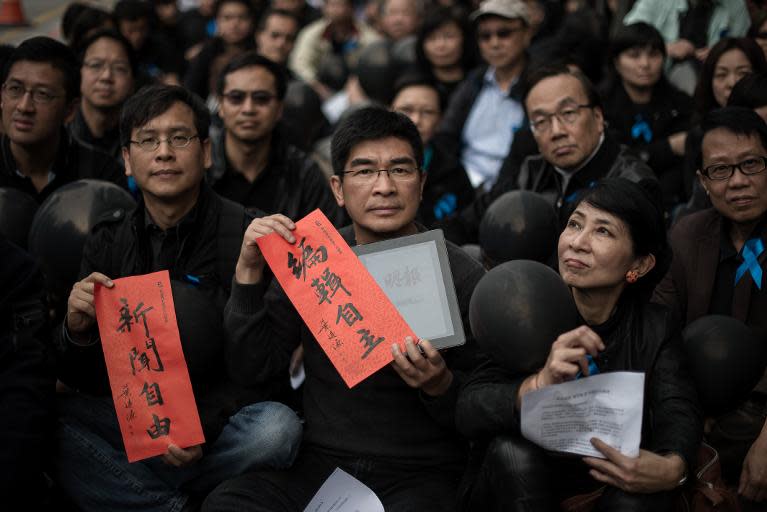 Demonstrators rally outside the offices of Chinese language newspaper Ming Pao, to protest against the replacement of its chief editor in Hong Kong, January 26, 2014