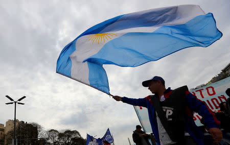 A man waves an Argentine national flag during a demonstration against the government’s economic measures in Buenos Aires, Argentina September 12, 2018. REUTERS/Marcos Brindicci