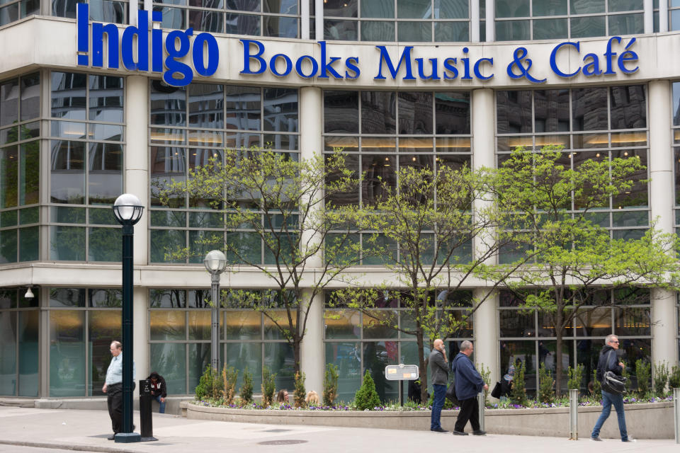 TORONTO, ONTARIO, CANADA - 2015/05/13: Indigo Books and Music cafe sign on the facade of the building. People walking before the building and the trees grow. (Photo by Roberto Machado Noa/LightRocket via Getty Images)