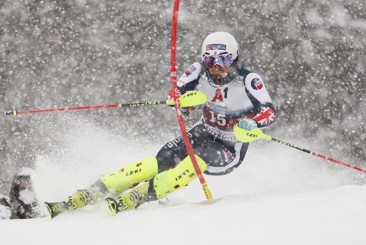 FILE - Britain's Dave Ryding speeds down the course during the first run of an alpine ski, men's World Cup slalom, in Kitzbuehel, Austria, Saturday, Jan. 22, 2022. When David Ryding gets to the start gate of the men's slalom at the Beijing Games on Wednesday, he knows expectations of a British skier will be high for once. Ryding became the first British winner in the 55-year history of the Alpine skiing World Cup, and on one of the circuit's most challenging slalom courses, when he triumphed in Kitzbühel last month. Now the 35-year-old is bidding to end his country's lengthy wait for a first Olympic medal in Alpine skiing. (AP Photo/Marco Trovati, File)