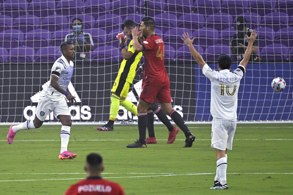 Toronto FC goalkeeper Quentin Westberg (16) and defender Omar Gonzalez (44) react after Orlando City forward Nani, left, scored a goal. while midfielder Mauricio Pereyra (10) celebrates during the first half of an MLS soccer match Saturday, June 19, 2021, in Orlando, Fla. (AP Photo/Phelan M. Ebenhack)