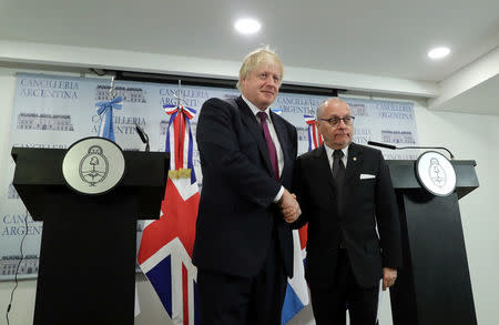 Britain's Foreign Secretary Boris Johnson and Argentina's Foreign Minister Jorge Faurie shake hands during a news conference in Buenos Aires, Argentina, May 22, 2018. REUTERS/Marcos Brindicci