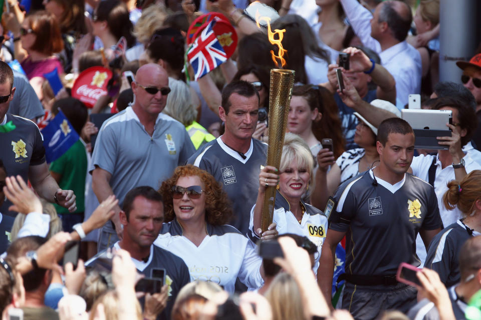 TV personalities Joanna Lumley (R) and Jennifer Saunders carry the Olympic Torch down King's Road on July 26, 2012 in London, England. The Olympic Flame is now on day 68 of a 70-day relay, the penultimate leg of the flames journey before being taken to the Olympic Park on Friday for the opening ceremony. (Photo by Dan Kitwood/Getty Images)