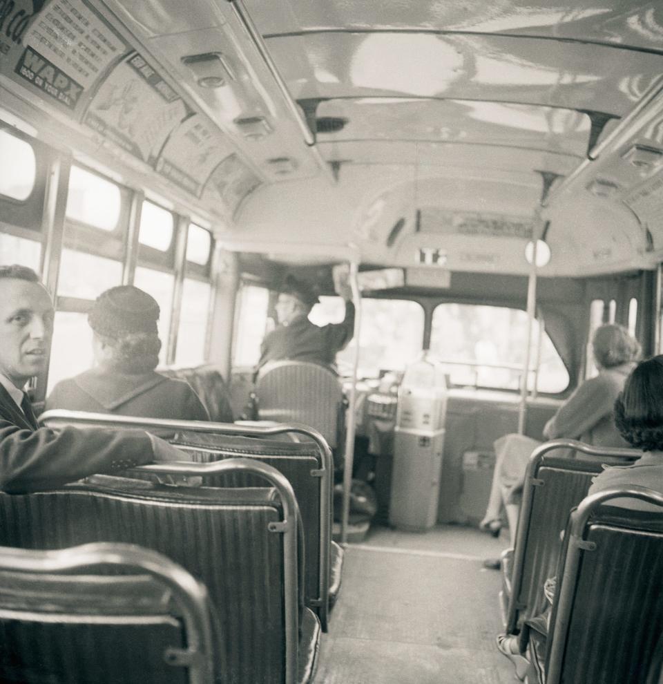 Rosa Parks, 43, sits in the front of a city bus here, on December 21, as a Supreme Court ruling banning segregation on the city's public transit vehicles took effect.