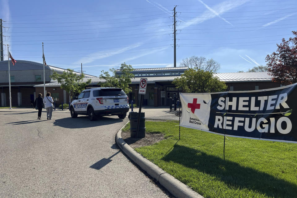 A Columbus Police car is parked in front of Dodge Park and Community Center in Columbus, Ohio on Thursday, April 18, 2024. The Red Cross set up a shelter for people living within a one-mile zone after a trailer carrying lithium batteries caught fire.(AP Photo/Patrick Orsagos)