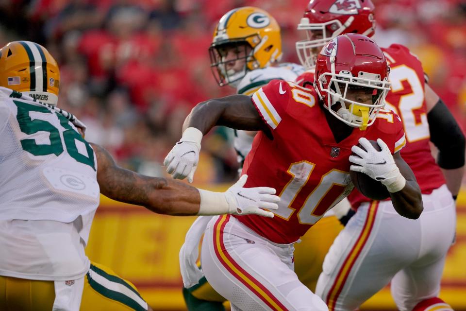 Kansas City Chiefs running back Isiah Pacheco (10) runs with the ball past Green Bay Packers linebacker Isaiah McDuffie (58) during the first half of an NFL preseason football game Thursday, Aug. 25, 2022, in Kansas City, Mo. (AP Photo/Ed Zurga)