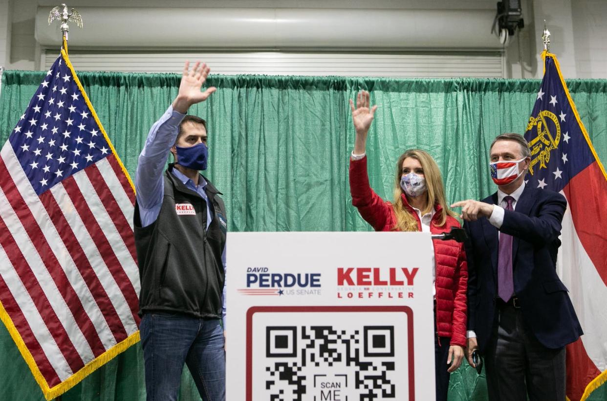 <span class="caption">(R to L) Georgia GOP Sens. David Purdue and Kelly Loeffler at a rally with Sen. Tom Cotton on Nov. 19, 2020 in Perry, Ga. Loeffler and Purdue face runoff elections against Democratic Senate candidates Jon Ossoff and Raphael Warnock on Jan. 5, 2021. </span> <span class="attribution"><a class="link " href="https://www.gettyimages.com/detail/news-photo/sen-david-purdue-and-sen-kelly-loeffler-wave-to-the-crowd-news-photo/1229686396?adppopup=true" rel="nofollow noopener" target="_blank" data-ylk="slk:Jessica McGowan/Getty Images;elm:context_link;itc:0;sec:content-canvas">Jessica McGowan/Getty Images</a></span>