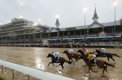 Promises Fulfilled (near post), ridden by Corey Lanerie and Justify, ridden by Mike Smith, lead the field into the first turn during the Kentucky Derby