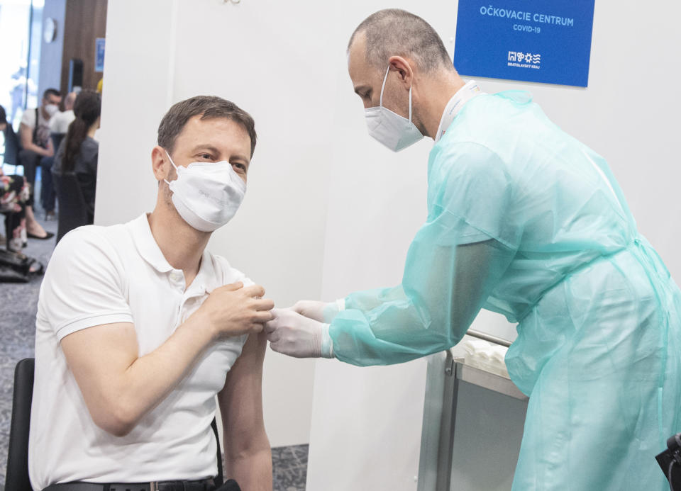 Slovakia's Prime Minister Eduard Heger receives his first AstraZeneca COVID-19 vaccination at the National Soccer Stadium in Bratislava, Slovakia, Saturday, May 1, 2021. The AstraZeneca coronavirus vaccine should remain part of Slovakia’s vaccination program the country’s Health Minister said on Wednesday, May 12. Slovakia on Tuesday halted use of the two-shot AstraZeneca vaccine after Slovakia’s State Institute for Drug Control concluded last week that the death of a 47-year-old woman who received the AstraZeneca was “likely” linked to the vaccine. (Jakub Kotian/TASR via AP)