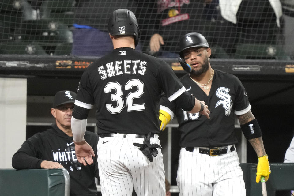 Chicago White Sox's Gavin Sheets is greeted at the dugout by manager Pedro Grifol, left, and Yoan Moncada after Sheets scored on Lenyn Sosa's sacrifice fly during the sixth inning in the second game of a baseball doubleheader against the Kansas City Royals Tuesday, Sept. 12, 2023, in Chicago. (AP Photo/Charles Rex Arbogast)