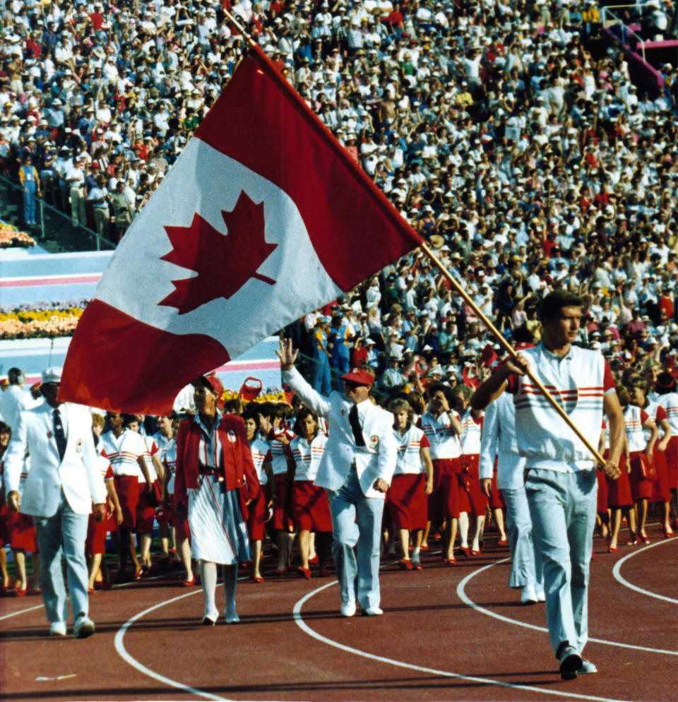 Alex Baumann carries the Canadian flag at the opening of the 1984 Summer Olympic Games