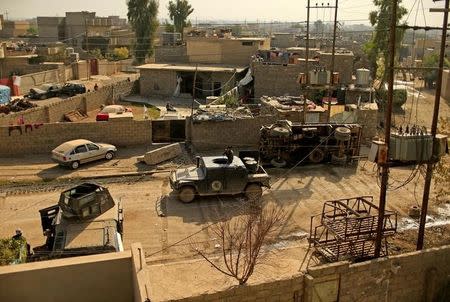 A military vehicle of the Iraqi Counter Terrorism Service drives in al-Zahraa neighborhood during a fight with Islamic State in Mosul, Iraq Novemebr 13, 2016. REUTERS/Ahmad Jadallah