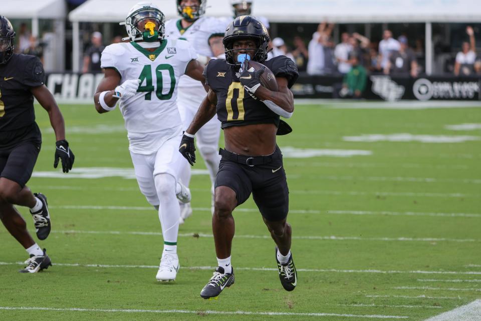 UCF Knights running back Johnny Richardson (0) runs the ball for a touchdown during the first quarter against the Baylor Bears on Sept. 30, 2023, at FBC Mortgage Stadium in Orlando, Florida.