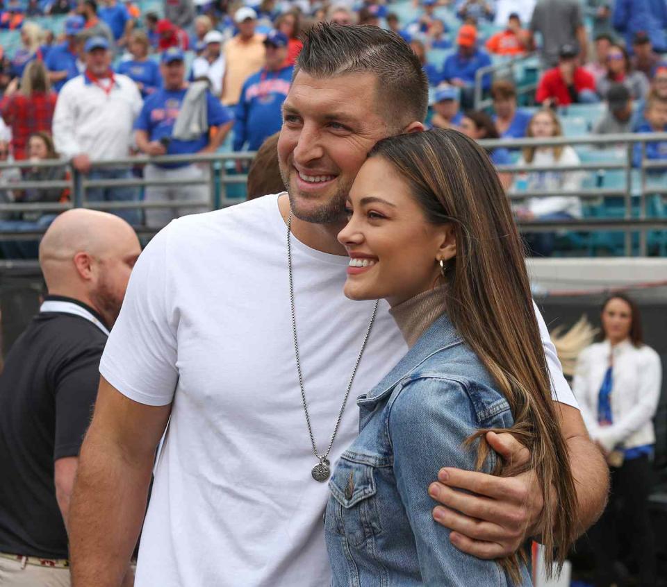 Tim Tebow poses for a photo with fiancé Demi-Leigh Nel-Peters during the game between the Georgia Bulldogs and the Florida Gators on November 2, 2019 at TIAA Bank Field in Jacksonville, Fl