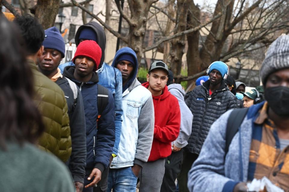 Migrants line up to collect free food at Tompkins Square Park. Helayne Seidman