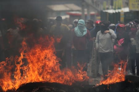 Trucks block main roads during protests after Ecuador's President Lenin Moreno's government ended four-decade-old fuel subsidies, in Calderon, near Quito