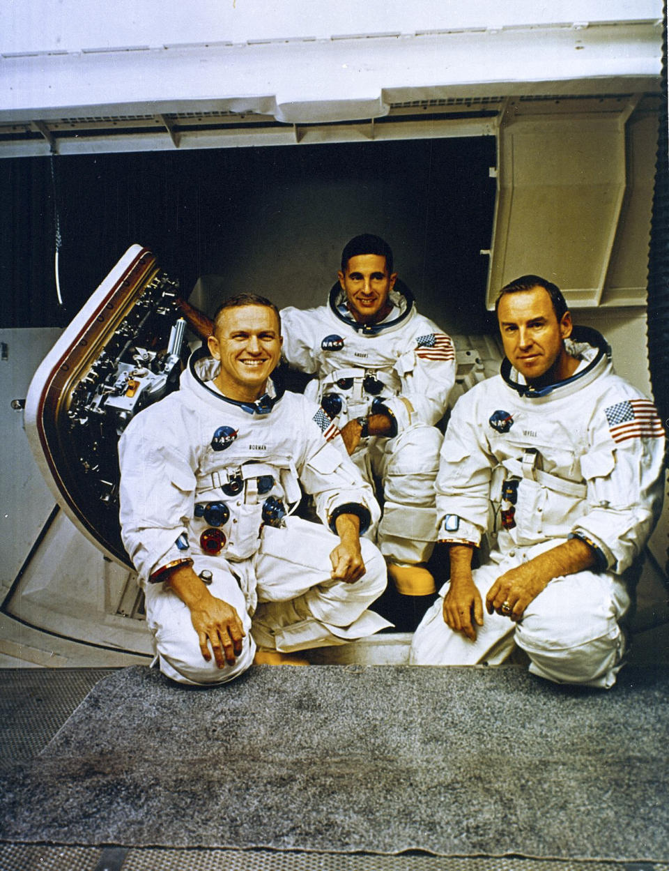 In this image provided by NASA, the Apollo 8 Crew from left, Frank Borman, commander; William Anders, Lunar Module Pilot; and James Lovell, Command Module pilot, pose in front of the Apollo mission simulator during training, Nov. 21, 1968. The National Transportation Safety Board has released its preliminary investigation into the fatal plane crash of the former astronaut. (NASA via AP)