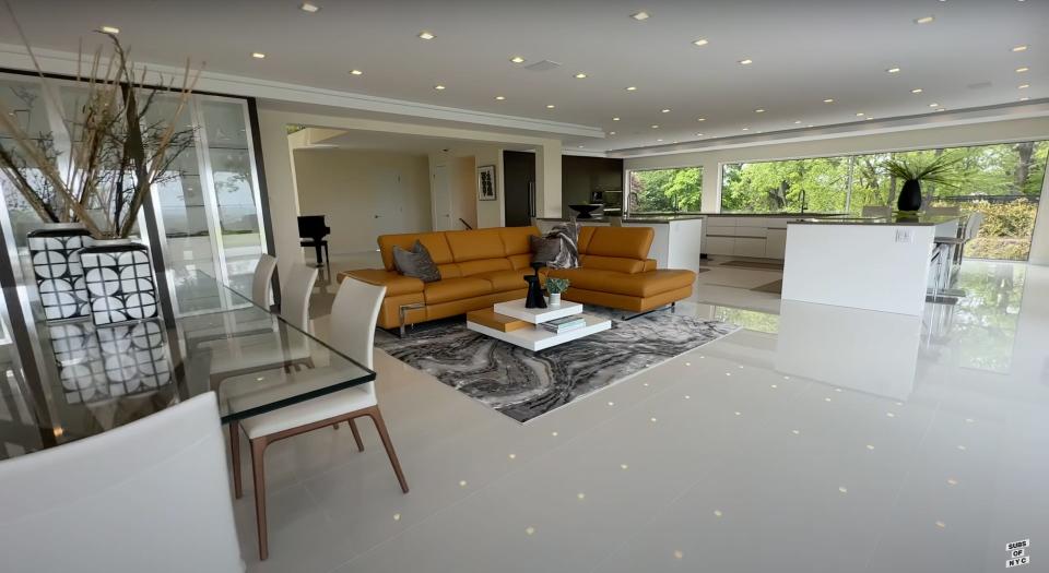 A seating area with couches next to a kitchen.